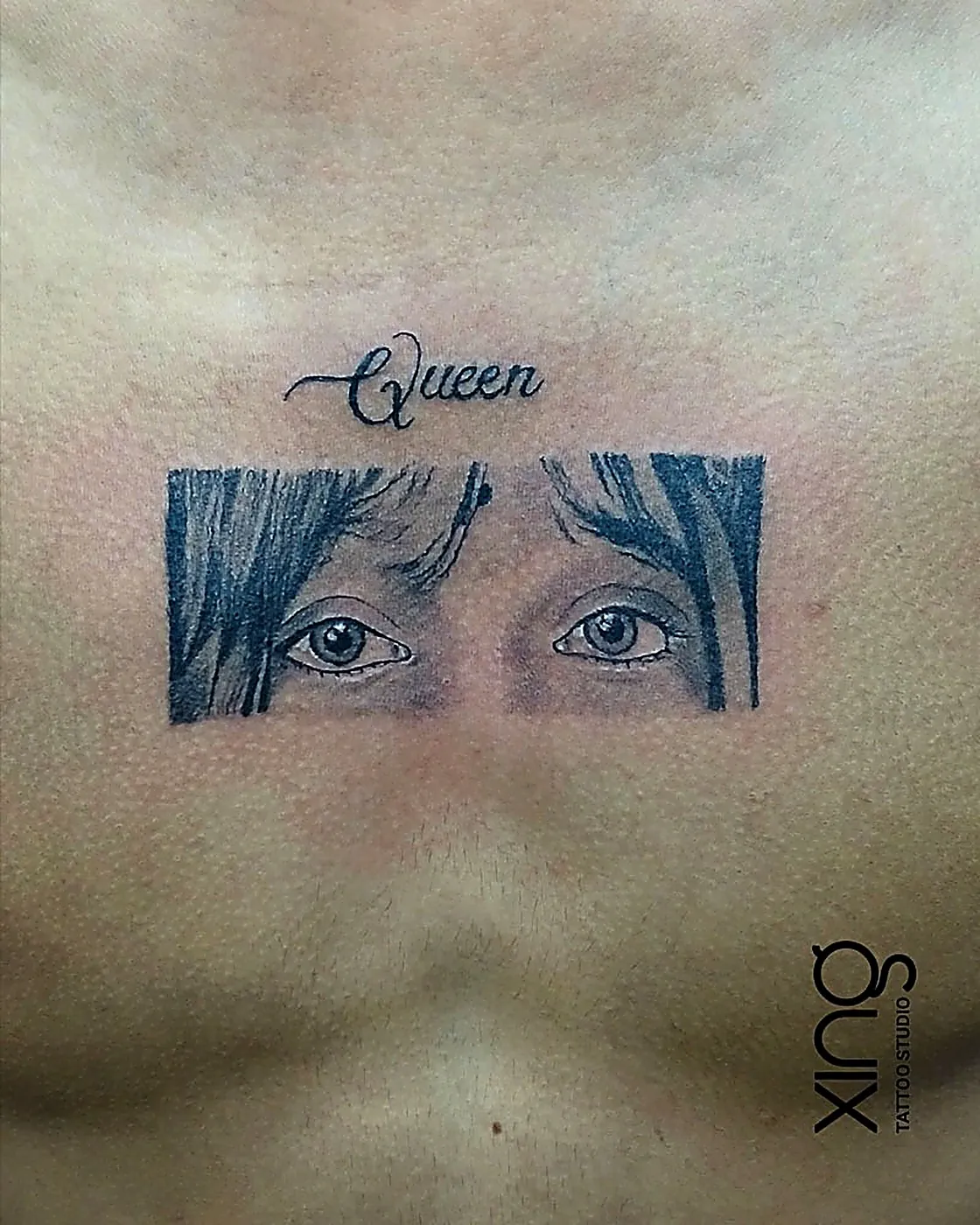 "Queen" eyes portrait tattoo on chest with fine realistic shading